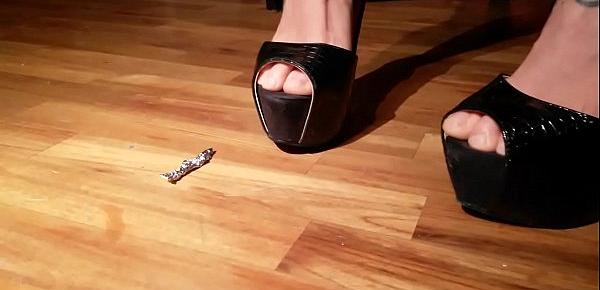  Sexy girl crushes objects under her shoes